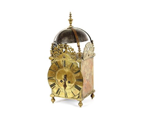 An Antique brass lantern clock, having pierced decoration of fish and foliage, circular dial raised on ball feet, 43cm high