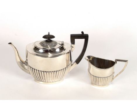 A George V silver teapot and cream jug, by Walker & Hall, having half fluted body decoration, the teapot with blackwood handl