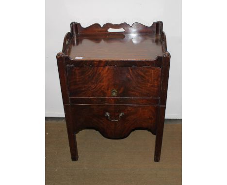A Georgian mahogany tray top commode, enclosed by a lifting flap with brass mount, pull-out section below, raised on chamfere