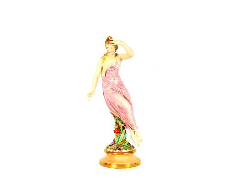 A fine late 19th Century Royal Worcester porcelain figure, modelled as a maiden seated on a floral encrusted tree stump in pi
