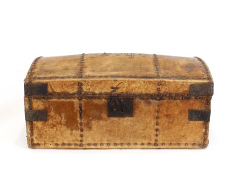 An Antique pony skin covered domed travelling trunk, having metal studs and side carrying handles, brass initialled HS, the i
