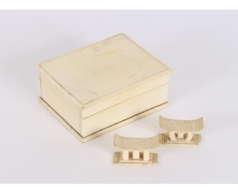 An ivory box, of plain form, 11.5cm wide; and a pair of chopstick rests in the form of stools