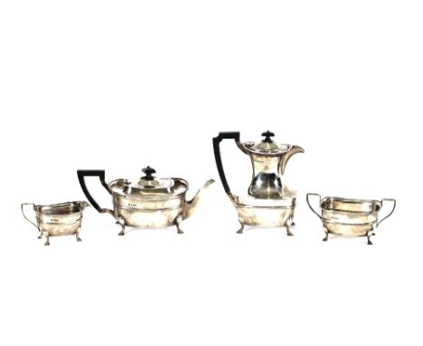 A George V silver four piece tea set, comprising teapot, hot water jug, milk jug and sucrier, of baluster form and raised on 