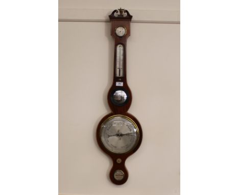 A 19th Century mahogany and boxwood strung banjo barometer, surmounted by a scrolled arch pediment and brass finial, silvered