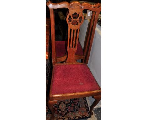 A set of four Edwardian Chippendale style beech dining chairs
