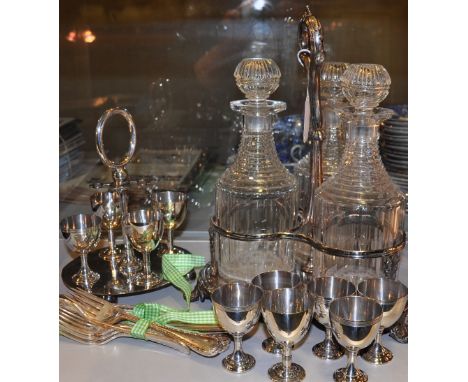 A Victorian style silver plated three bottle decanter stand, with three associated 19th Century ring necked decanters, an egg