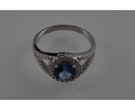 A silver cubic zirconia and blue topaz dress ring