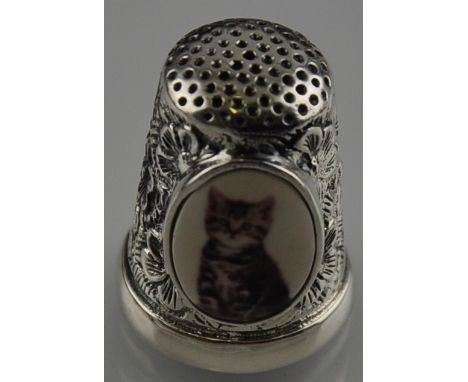 A silver and enamel thimble depicting a kitten