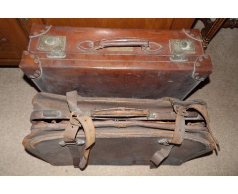 Two vintage leather suitcases.