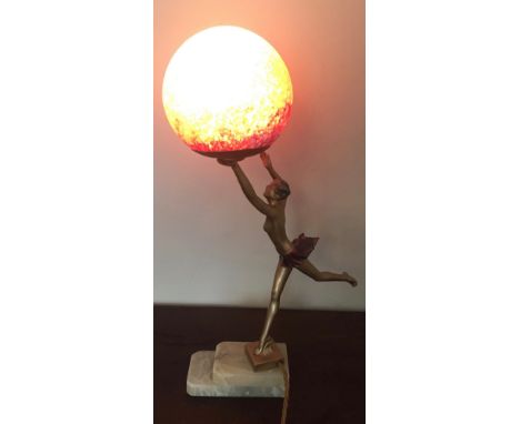 Art Deco lamp a scantily clad lady holding a globe probably spelter.