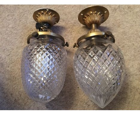 Two cut glass and brass light fittings.
