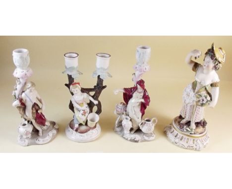 A 19th century Sitzendorf figure of a woman with grapes and flowers, a pair of continental candlestick figures and another ca