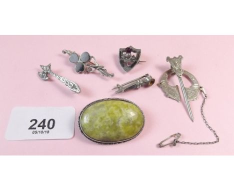 Five silver Celtic brooches and a white metal one