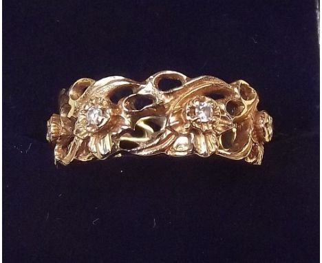 A 14ct gold diamond set floral design eternity ring by Stuart Devlin for Franklin Mint, size R