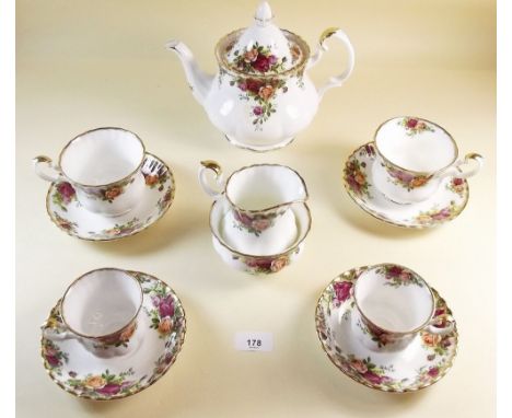 A Royal Albert Country Roses tea and coffee service comprising:- teapot, two sugars, cream jug, milk jug, ten tea cups and sa