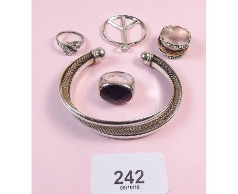 Three silver rings, silver bangle and pendant