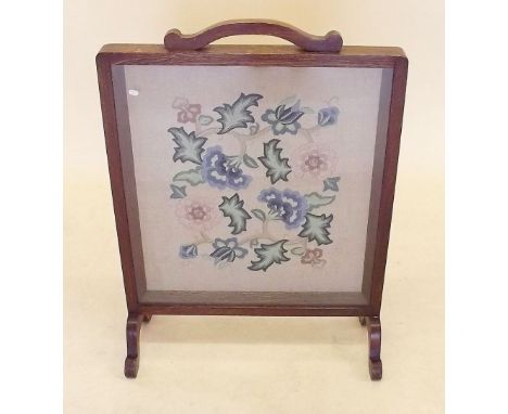 An early 20th century mahogany framed embroidered fire screen