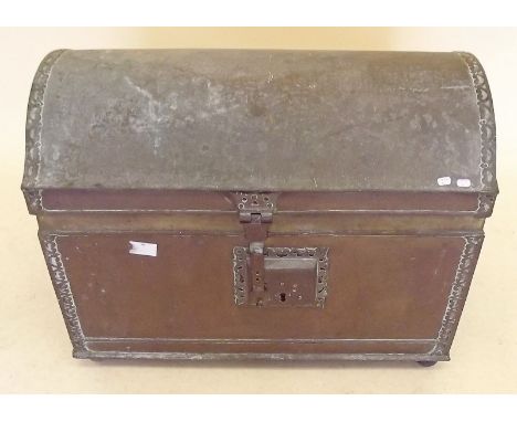 A brass dome top trunk with applied decoration and lock