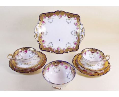 An Edwardian Cauldron tea service comprising:- ten cups, twelve saucers, six side plates, sugar bowl and cake plate
