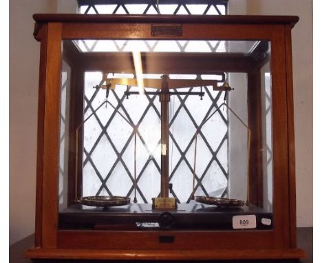 A set of chemical scales in glazed case