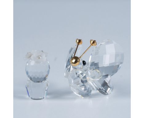 An enchanting butterfly rests peacefully, adorned with gilded facial accents and sparkling crystals atop its delicate antenna