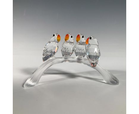 The four faceted clear crystal Lovebirds have Fire Opal beaks, and Jet black eyes on white backgrounds. They are perched on a