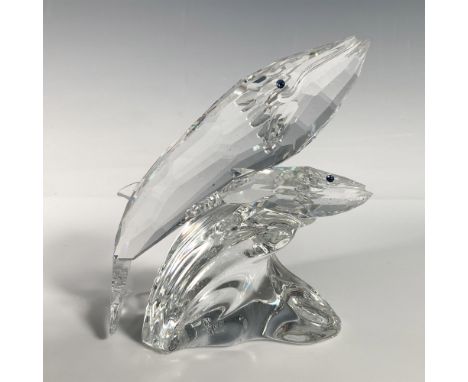 An adorable mother and child whale swim side by side over a wave, both showcasing stunning blue eyes. Swarovski backstamp. Th
