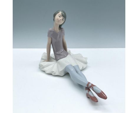 Glossy finish modeled as a young girl seated. Lladro backstamp. This item has its original box, dimensions: 13''L x 7.25''W x