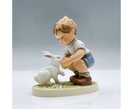 Figure of a boy crouching down to pet a white rabbit over a patch of grass. Exclusive Edition 1999/2000 M.I. Hummel Club. Goe