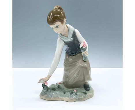 Glossy porcelain. Depicts a girl picking flowers. Lladro backstamp. This item has its original box, dimensions:12.25''L x 7.5