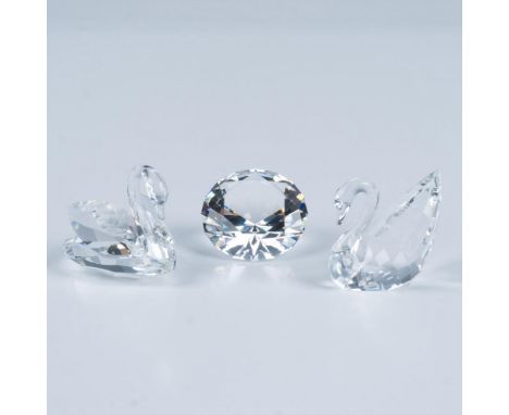 An exquisite duo of crystal clear swans one elegantly depicting the silhouette of a swan in graceful swim and the other showc