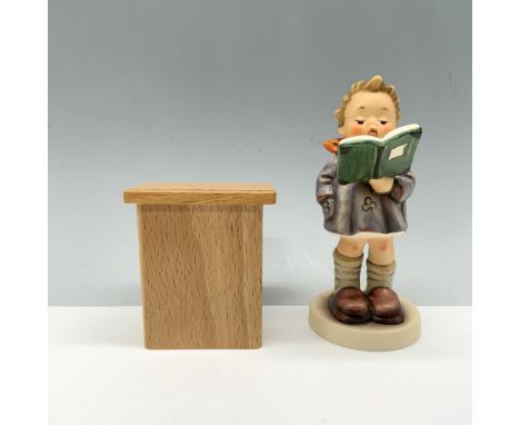 Ravishing figure featuring a young child reading from a book in front of a podium. Goebel backstamp. Certificate of Authentic