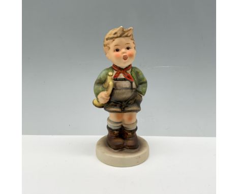 Adorable figure of a young kid wearing a scarf and jacket while holding his favorite instrument. Germany backstamp. This item