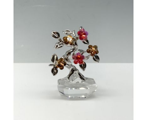 Flower Dreams Collection bonsai tree with peach and pink petal flowers on a rhodium branch that is placed on a clear flower p