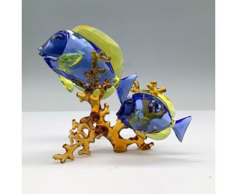 Stunning pair of blue and yellow doctorfish gracefully swim together, crafted in crystal within a coral reef setting, capturi