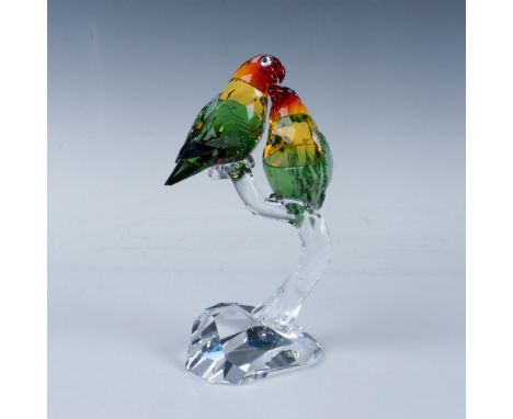 A pair of birds crafted in mixed brilliant colored crystals of red, yellow and green. The two birds display an affectionate g