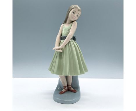 Glossy porcelain. Features a shy ballerina dressed in a green dress. Lladro backstamp. This item has its original box, dimens
