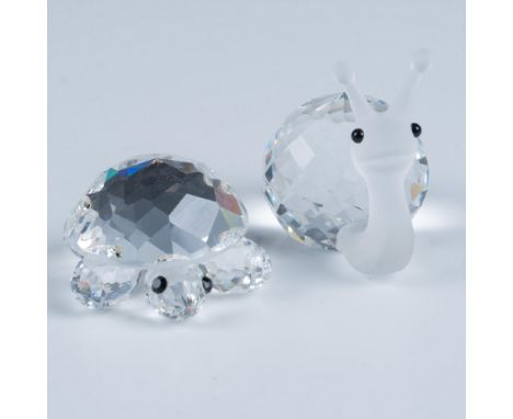 A delightful snail with a round shell and a frosted body pairs perfectly with a turtle that has a clear shell, both charmingl