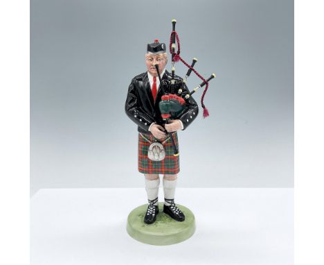 1993 - First Year of Issue. Hand made and hand decorated figure of a man playing the bagpipes. Red, green and black coloratio