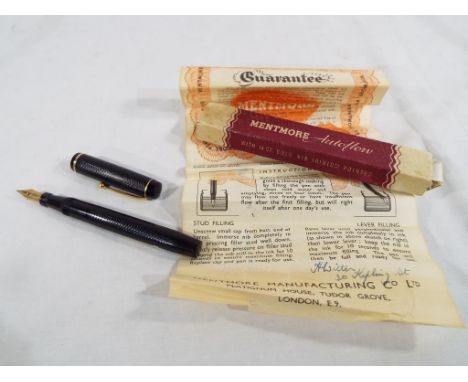 A Mentmore Autoflow fountain pen with black barrel and yellow metal nib marked 14 carat - original box and instruction leafle
