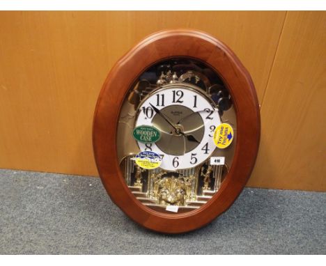 A Rhythm Clarion Tone System Superior Sound automaton wall clock with Swarovski Elements detailing to the pendulum, automatic