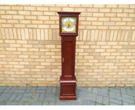 A contemporary granddaughter clock, Westminster chiming spring wound movement by Metamec, square brass dial with applied chap