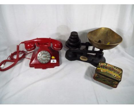 A retro style telephone, red and a set of Salter cast iron weighing scales with weights (2)