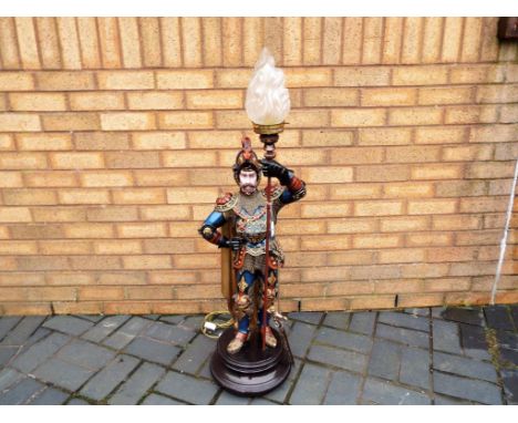 An unusual good quality wall standing lamp in the form of a knight with a glass shade approx 110cm (h) inscribed on the back 
