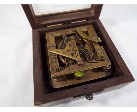 A brass sundial compass, cased 5.5 cm x 10 cm x 10 cm. Est £20 - £30
