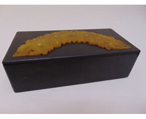 Chinese hardwood puzzle box, the pull off cover inset with a carved jade plaque, 22 x 11 x 6.5cm