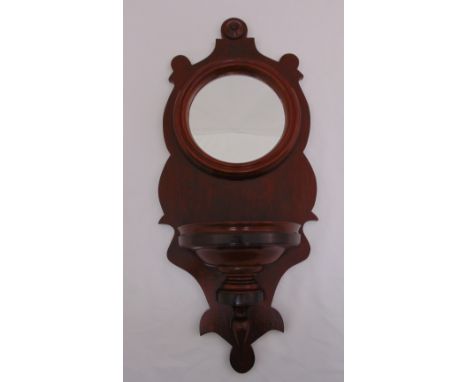 A mahogany wall bracket inset with circular mirror, 74.5 x 32cm