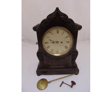 A Victorian mahogany chiming bracket clock, shaped rectangular with leaf and scroll carved swags, white enamel dial with Roma