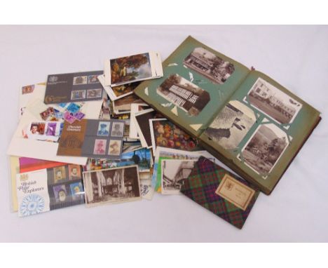 A quantity of vintage postcards to include an album, loose cards and first day covers