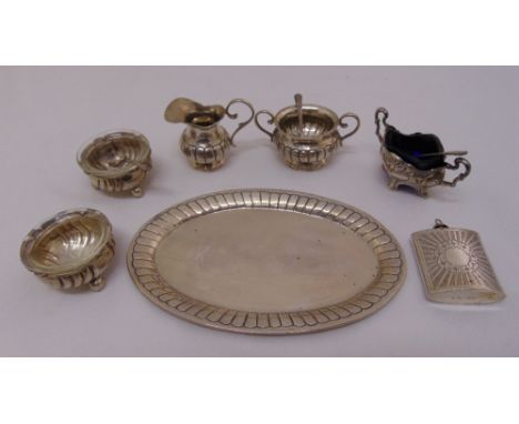 A quantity of white metal to include a miniature tray, milk jug, sugar bowl three salts with glass liners and a miniature fla